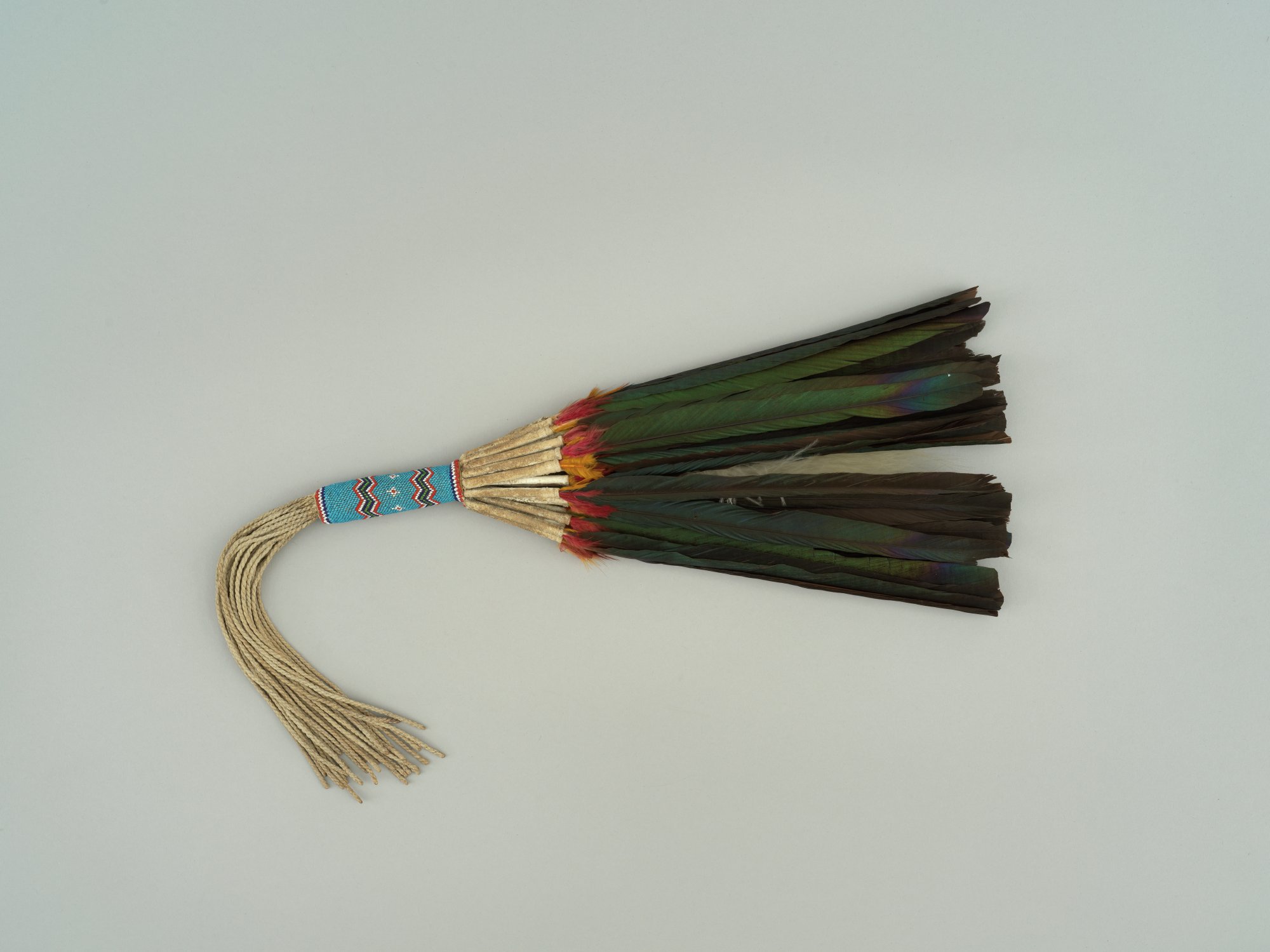 Magpie feather loose fan with beaded handle and twisted fringe