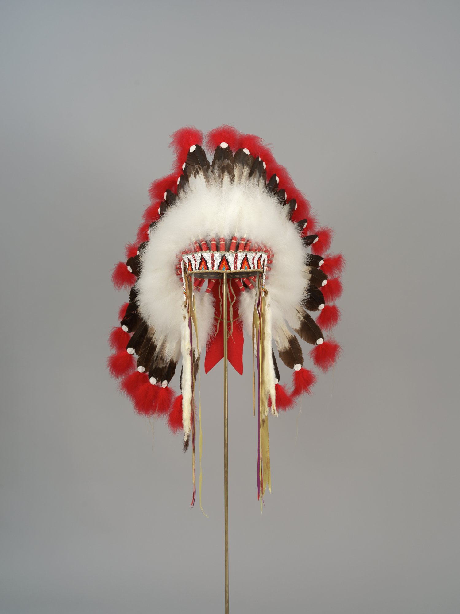 Eagle feathered headdress with ermine strips and beaded headband